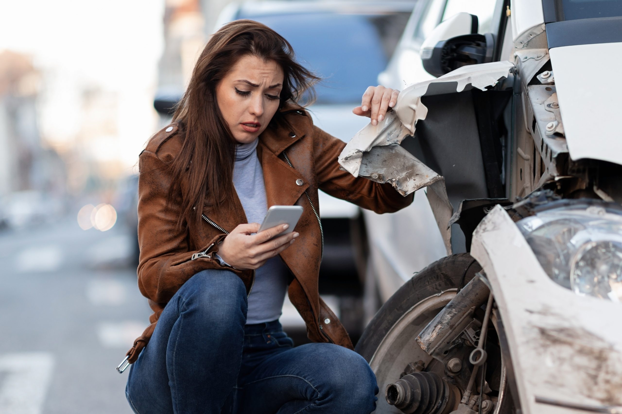 Young Sad Woman Text Messaging Smart After Car Crash Road Scaled 575 Law Group